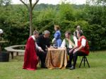Lady Macbeth chuckles at the Lords trying to operate the ouija board
