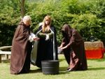 Witches warming their hands over a welcoming polyurethane pot