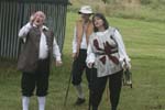 Dogberry tosses a coin to decide whose ticket it is, while Verges dozes quietly