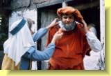 Mistress Ford gives Sir John's a last beard a last touch of makeup