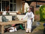 The Hostess is shocked to see that Sly has been run over by a table