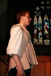 A servant models for the stained glass window artist
