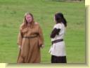 The washerwomen share a really juicy bit of gossip.